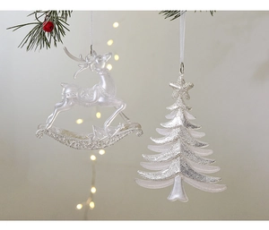 Sparkling silver glitter reindeer and Christmas tree ornaments on pine branches
