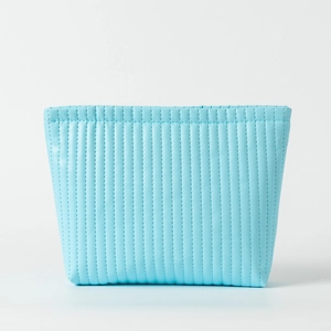 Close-up of sky blue PU leather toiletry bag with vertical quilted stitching detail