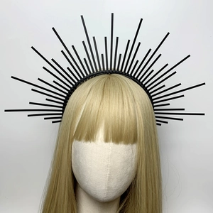 Detailed view of a black sunburst halo crown with long spikes on a model headpiece