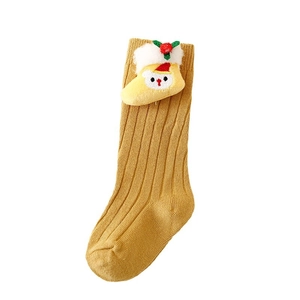 Yellow Christmas knit socks for kids with cute reindeer doll decor on white background