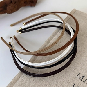 Minimalist leather headbands with stitching in assorted neutral colors and gold tips