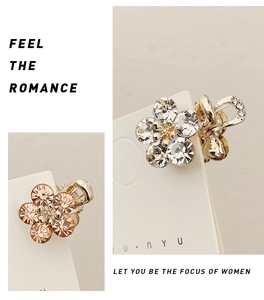 Detailed macro view of mini crystal flower hair claw clips in silver and gold finish