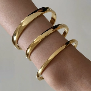 Set of minimalist polished gold stainless steel bracelets with side clasp closure