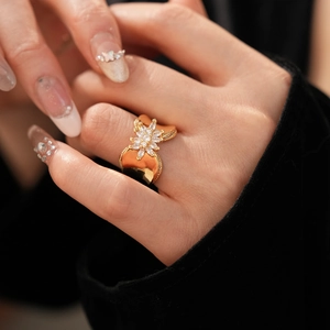 Macro detail of 18K gold plated flower ring with cubic zirconia on model finger