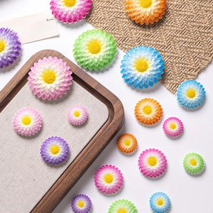 Colorful resin daisy flower charms in various sizes for DIY crafts and accessories