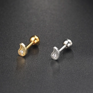 Detail of gold and silver teardrop zircon cartilage studs with spherical screw backs