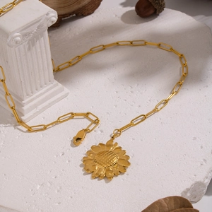 Detail of golden sunflower pendant on a paperclip chain with lobster clasp