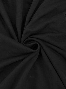 Close-up of soft black knit fabric texture showing the breathable material of men's shorts