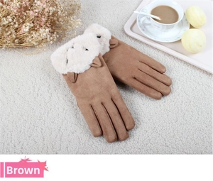 Detail of winter suede gloves with plush faux fur trim and cute cat ear decoration