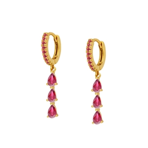 Detailed macro of gold drop earrings featuring pear-cut pink stones and zircon stones