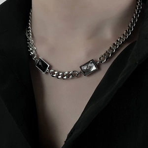 Close-up of titanium steel Cuban chain necklace with black gem and white crystal inlay