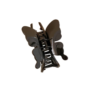 Elegant black butterfly claw clip with glossy finish and metal spring on white background
