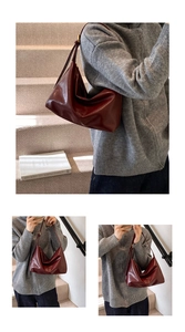 Detailed view of the dark red leather tote bag with elegant thin shoulder straps