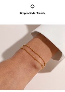 Detailed view of 18K gold plated minimalist beaded double layer bracelet on wrist