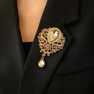 Champagne gold flower brooch with crystal droplets on a classic black suit lapel