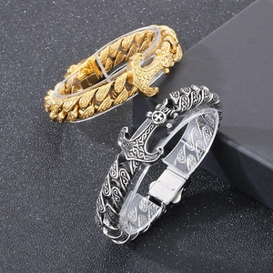Detail of gold and silver anchor clasp bracelets showing the 316L stainless steel engraving