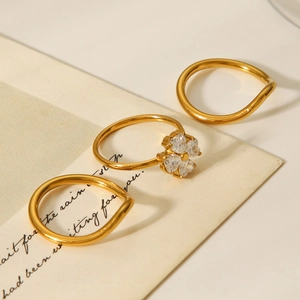 Detailed set of gold titanium steel rings with clover zircon and wavy minimalist bands