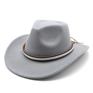 Close-up of a light grey cowboy hat featuring a silver star studded decorative band