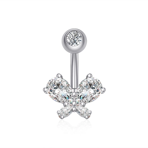 Macro shot of silver butterfly belly ring with sparkling zircon stones on white surface