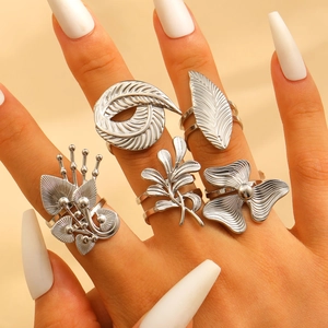 Detailed view of bohemian silver stainless steel rings with floral and leaf motifs
