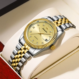 Close-up of luxury quartz watch dial with diamond markers and date window on a display pillow