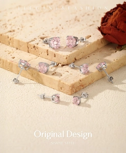 Macro shot of s925 silver stud earrings with round pink stones in four-prong setting