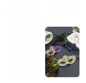 Close-up of elegant lace and feather masks with glitter sequins for costume parties