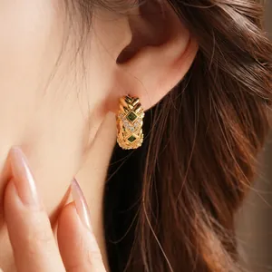 Vintage style gold woven earrings with green zircon stones and rhinestone accents