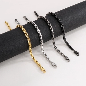 Titanium steel link chains in gold, silver, and black on a cylinder display
