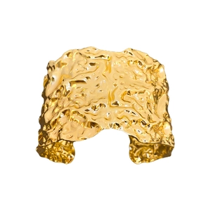 Modern wide golden cuff bracelet with geometric crumpled metal texture in a minimalist design