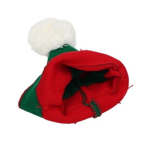 Macro detail of red and green knitted Christmas hat with interior texture and loose threads