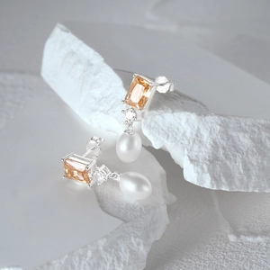 Detail of S925 silver pearl earrings with champagne zircon stones and teardrop pearls