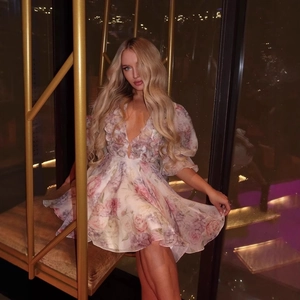 Pink floral puff sleeve mini dress with deep V-neck and ruffled floral petal details