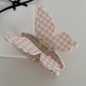 Macro detail of butterfly hair claw clip with pink gingham and tiny floral pattern