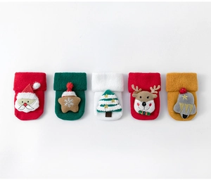 Detail of five pairs of thick cotton baby Christmas socks with 3D festive characters