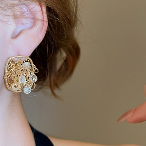 Detailed close-up of 18k gold plated hollow wire stud earrings with crystal drops