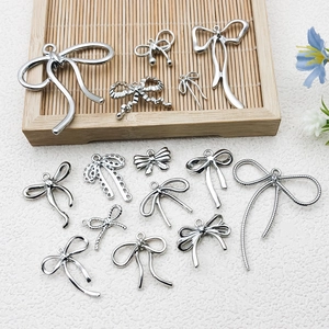 Selection of silver bow-knot charms with hollow designs for DIY jewelry crafting and accessories
