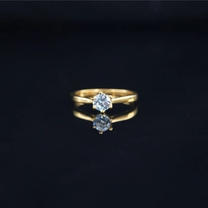 Elegant six-prong solitaire ring with round moissanite in a classic gold setting