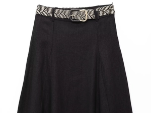 Close-up of black linen skirt texture with a woven belt and gold metal buckle