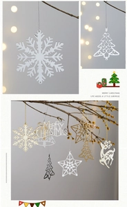 Flat metal Christmas tree ornaments in gold and silver showing snowflakes and reindeer