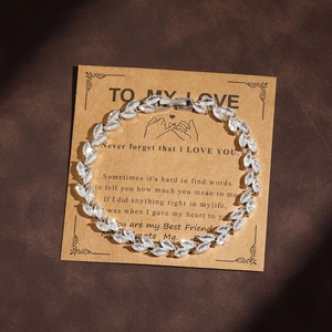 Elegant silver wheat ear bracelet with cubic zirconia on a message gift card display