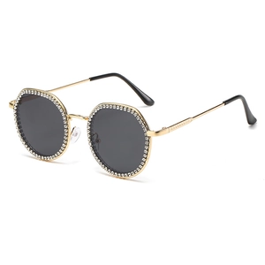 Vintage gold metal sunglasses with diamond encrusted round lenses and dark grey tint