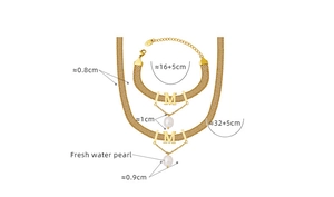 Detailed view of gold mesh chain necklace and bracelet set with freshwater pearl and M pendant