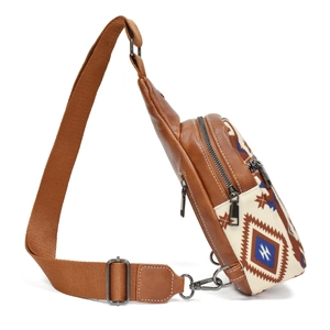 Side view of bohemian crossbody bag with ethnic patterns and brown leather accents