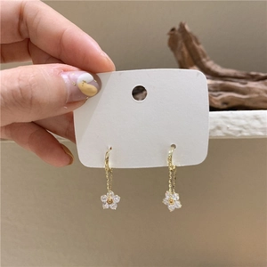 Elegant gold flower tassel earrings with sparkling crystals and a sleek hanging design