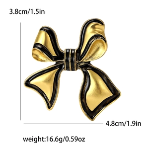 Detail view of enamel bow brooch with dimensions 3.8x4.8cm and weight 16.6g