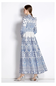 Detail of blue and white vintage paisley print on long lantern sleeve dress with smocked waist