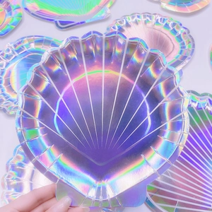 Detail of shell-shaped party plates with iridescent holographic finish and texture