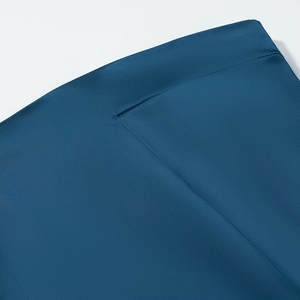 Detailed view of dark blue satin fabric texture and premium stitching on dress