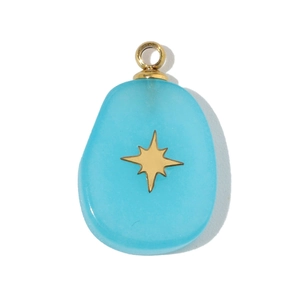 Macro detail of oval light blue resin pendant with a golden star and metal hook
